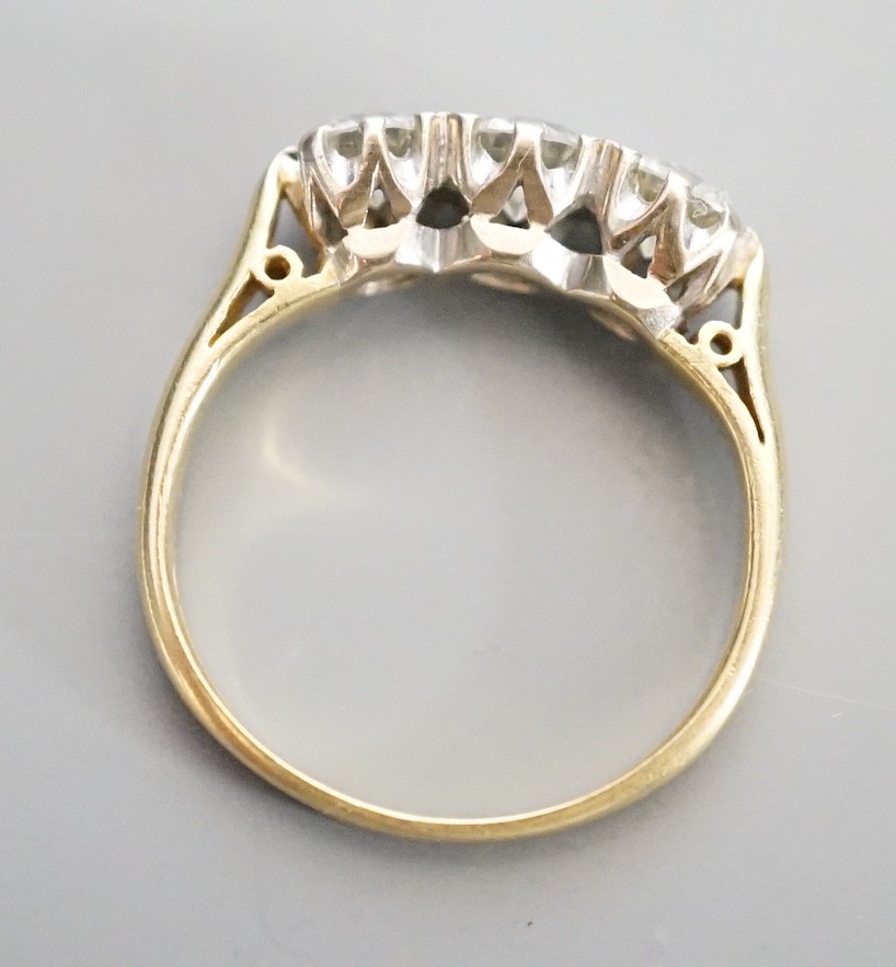 A modern 18ct gold and three stone diamond ring, size L, gross weight 3.3 grams